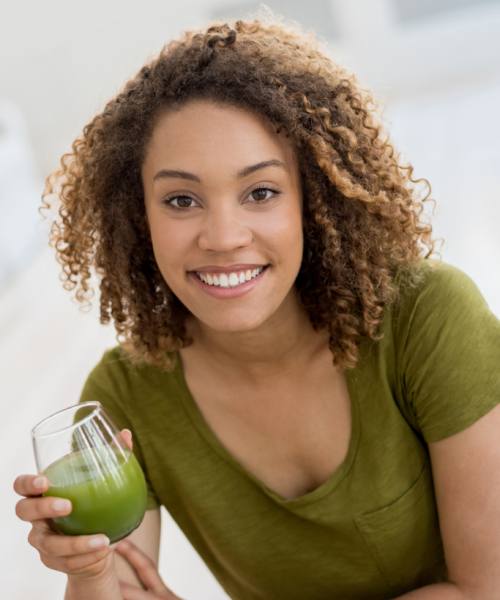 Woman drinking green juice